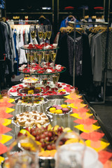 buffet table with snacks, cakes, drinks and champagne