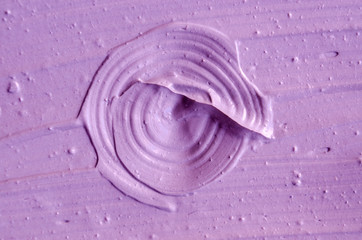 Lavender face cream (mask) texture close up. Brush strokes. Selective focus. Abstract violet background 