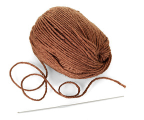 Woolen skein of brown yarn and crochet hook isolated on white