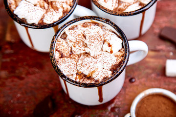 Hot chocolate with marshmallow candies on wooden background.