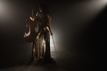 The cellist performs on stage.