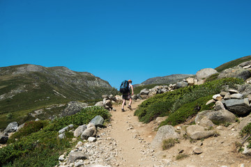 hiker walking on Besseggen ridge in Jotunheimen National Park, Norway