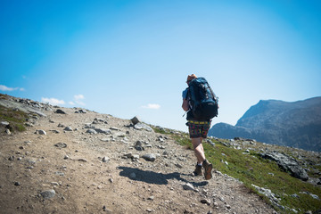 Naklejka premium tourist hiking on Besseggen ridge in Jotunheimen National Park, Norway