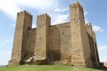 The middle ages stone made ancient castle Castillo de los Ba&ntilde;ales, with towers and defensive merlons, in Sabada, a small typical rural town in the Aragon region, Spain