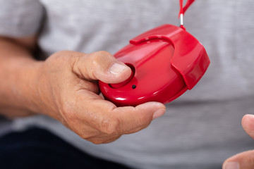 Man Holding Personal Alarm