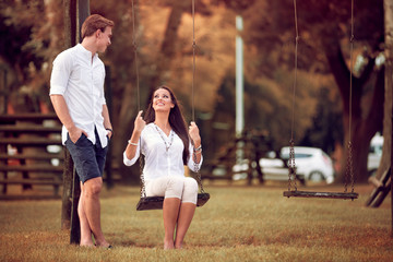 couple having fun in the park autumn