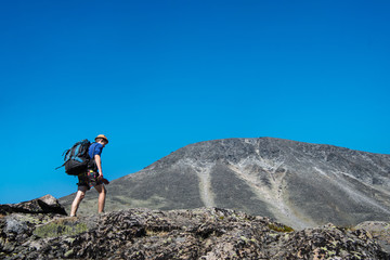 Fototapeta premium traveler hiking on Besseggen ridge in Jotunheimen National Park, Norway