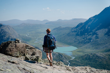 man hiking on Besseggen ridge over Gjende lake in Jotunheimen National Park, Norway