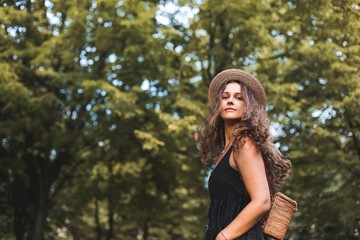 girl traveler in a straw hat in the forest.