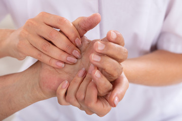 Doctor Examining Patient's Wrist