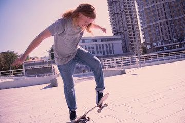 My equipment. Professional freestyler being in air while looking at his skateboard