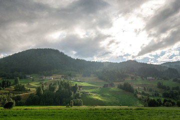 Obraz premium scenic landscape with cloudy sky and mountains in Gudvangen, Neirofjord, Norway
