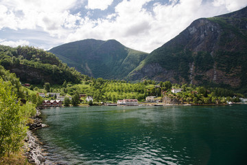 houses in Flam village near beautiful mountains on coast of majestic Aurlandsfjord (Aurlandsfjorden), Norway