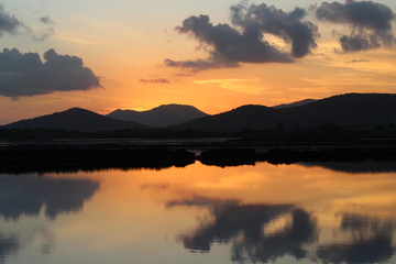 Naklejka na ściany i meble Sunset over water in ses salines, ibiza: water reflections