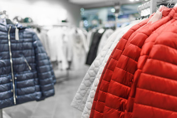 Women's down jackets on hangers in a women's clothing store