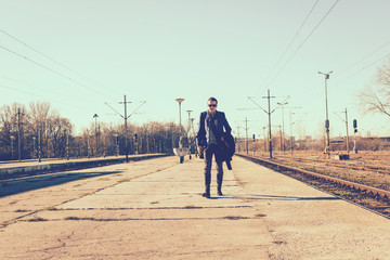 Businessman walking on train station platform.