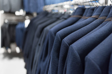 Men's jackets on hangers in a men's business clothes shop