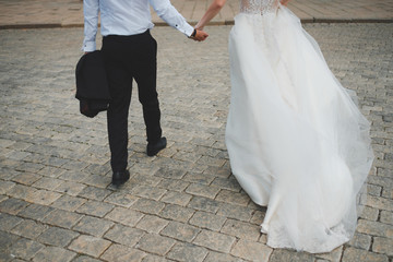 Fototapeta na wymiar bride and groom walking on the street