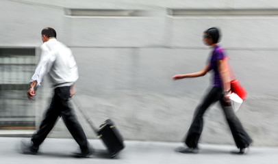 motion blurred business people walking on the street