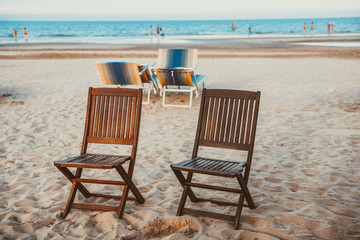 Beach wooden chairs on the sand