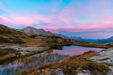 lake in mountains alps with cloudy sky at sunset