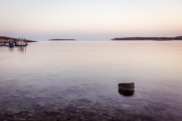 dawn over beach and sea in mediteranean greek cycladic island paros