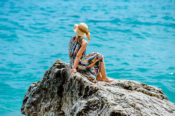 Girl on a rock against the sea 