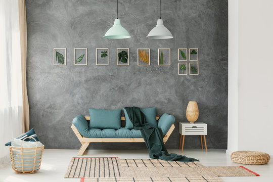 Wicker Basket, Ottoman And Rugs On The Floor Of An Eco Style Living Room Interior With Mint Green Decorations And Gray Wall