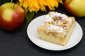 apple cake, apple and sunflower on black slate