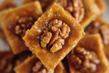appetizing baklava with nuts and honey closeup on a wooden background
