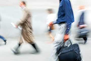 motion blurred business people walking on the street