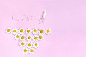 Word CLEAN from white thread hygienic female tampon and chamomile flowers in form panties on pink background. Concept hygiene health women and adolescents during menstrual cycle. Flat Lay, Copy space
