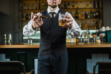 senior man with cigar and whiskey on the bar counter. No face