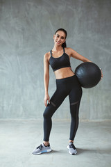 Sports Woman In Black Sportswear Training With Fitness Ball