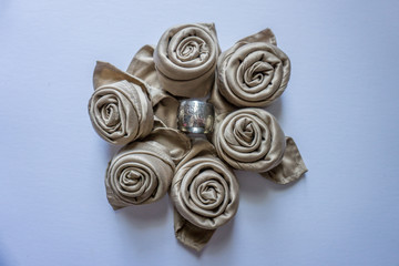 Golden napkin roses in a circle with silver metal ring in middle decoration table events holidays...