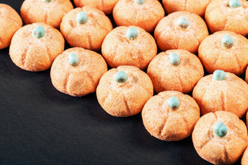 marshmallows in the shape of a pumpkin for the holiday Halloween on a black background.  