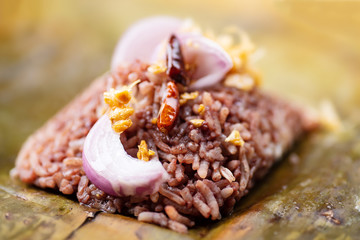 Northern Thai food (Khao Kan Chin or Khao Ngiao), steamed pudding with rice, rice mixed with pork blood served with shallot and fried chopped garlic on top