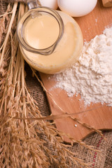 Spikelets of wheat, eggs, milk, flour. Ingredients for bakery products