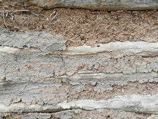 stone wall covered with clay plaster.