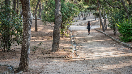 Woman jogging down path in Athens
