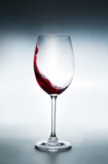 Wine splashing in glass, studio shot