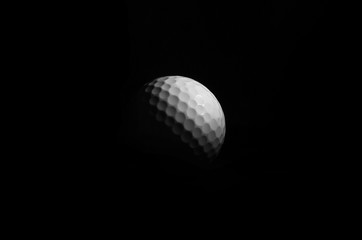 Golf ball in black background