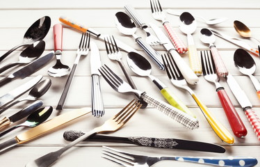 Collection of modern and antique cutlery, top view
