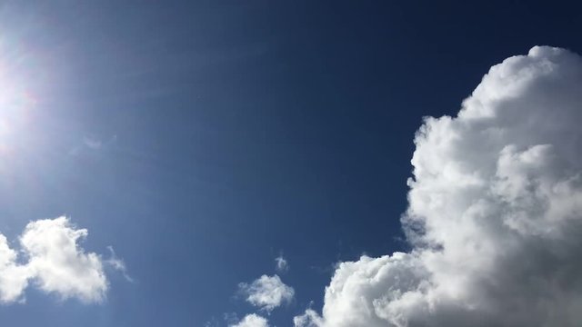 video timelapse clouds fly across the sky in the background of the sun