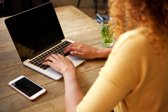 Behind Of Young Woman Using Laptop Computer