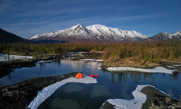 Orange tent at lake in mountain In Spring