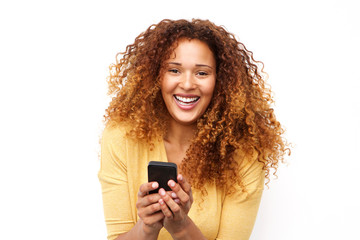 Close up laughing young woman with mobile phone against white background
