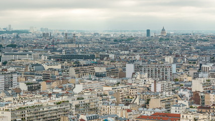 Obraz premium Aerial panorama above houses rooftops in a Paris timelapse
