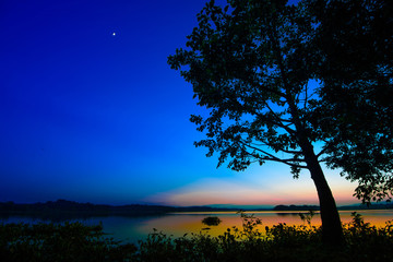 Naklejka na ściany i meble Natural beautiful twilight over lake with star