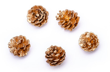 Obraz premium five golden pine cone on a white background